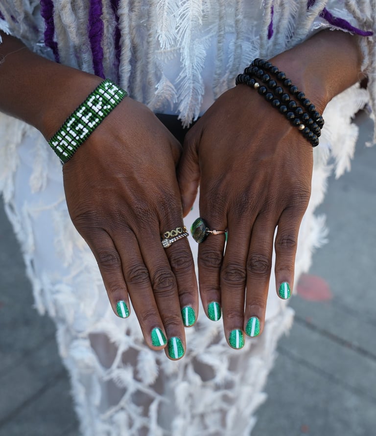a woman with green nails and a white dress