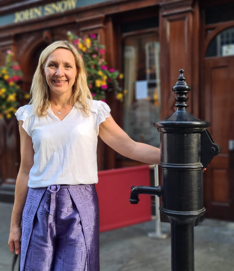 Dr Helena Seth-Smith standing at the John Snow water pump, London