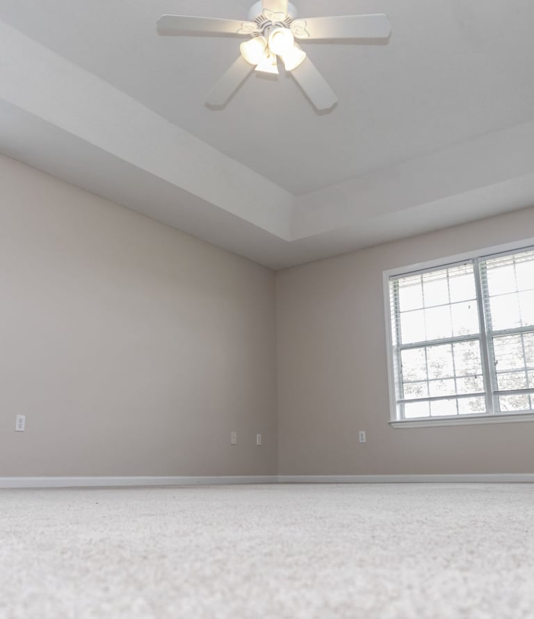 a ceiling fan in a room with a new ceiling