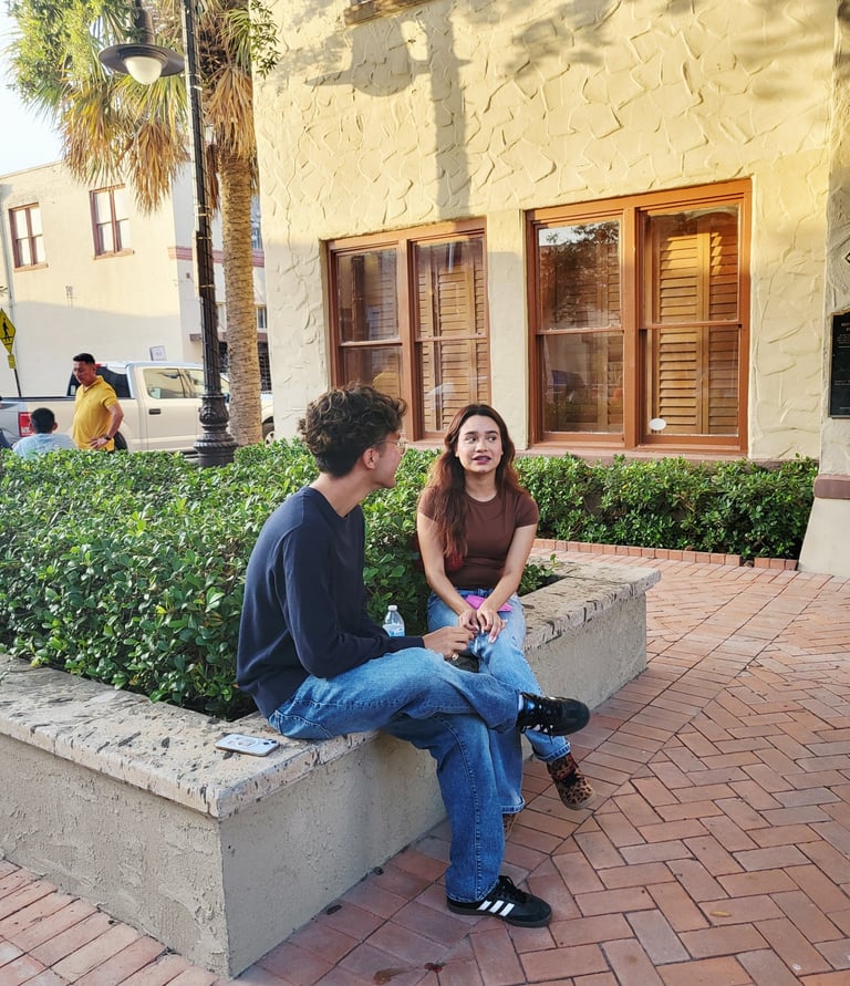 A young man next a girl talking