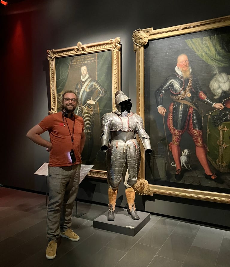 Image of Gabriele Culot in front of a suit of armour during a museum visit.