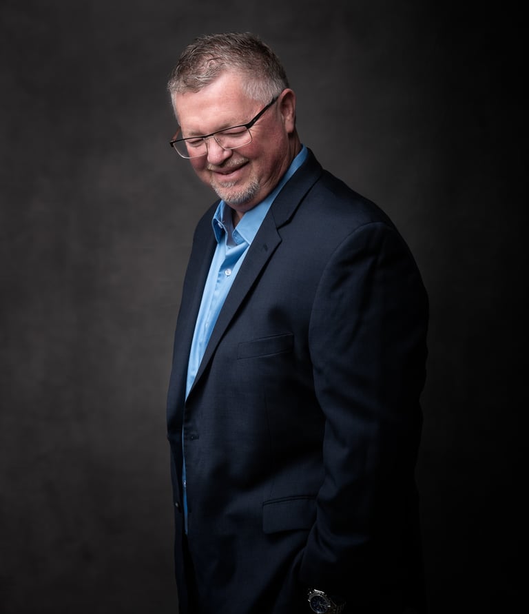 a professional image of a man in a suit and tie smiling