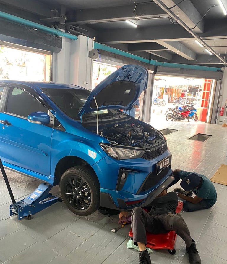 a man working on a car in a garage