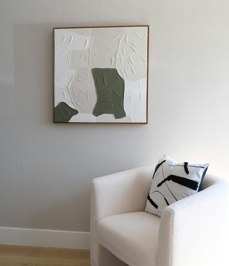 Minimal cozy living room with neutral wall art, and a soft sofa