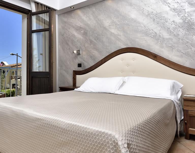 a bed room with a bed and a balcony