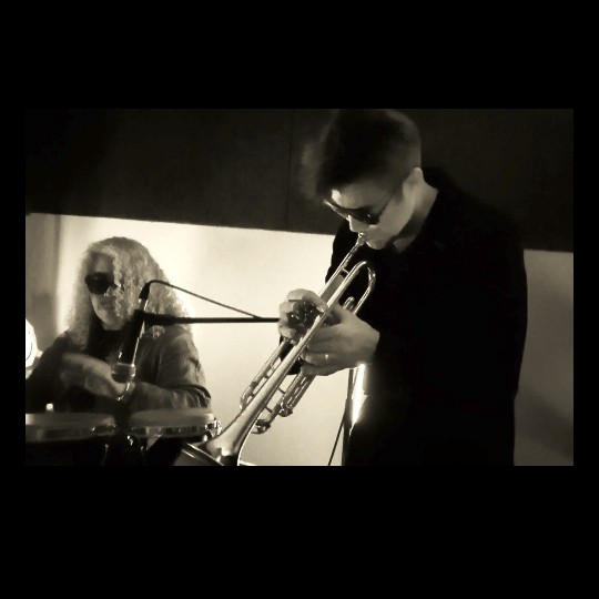Benvenuto Electrojazz playing trumpet alongside percussionist, Nomads Spirits duo