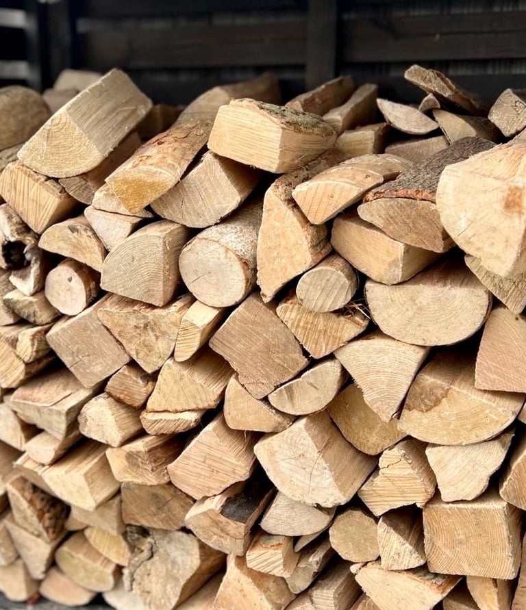 Stacked kiln dried hardwood logs in a log store at Ouse Firewood in Wyton Huntingdon Cambs