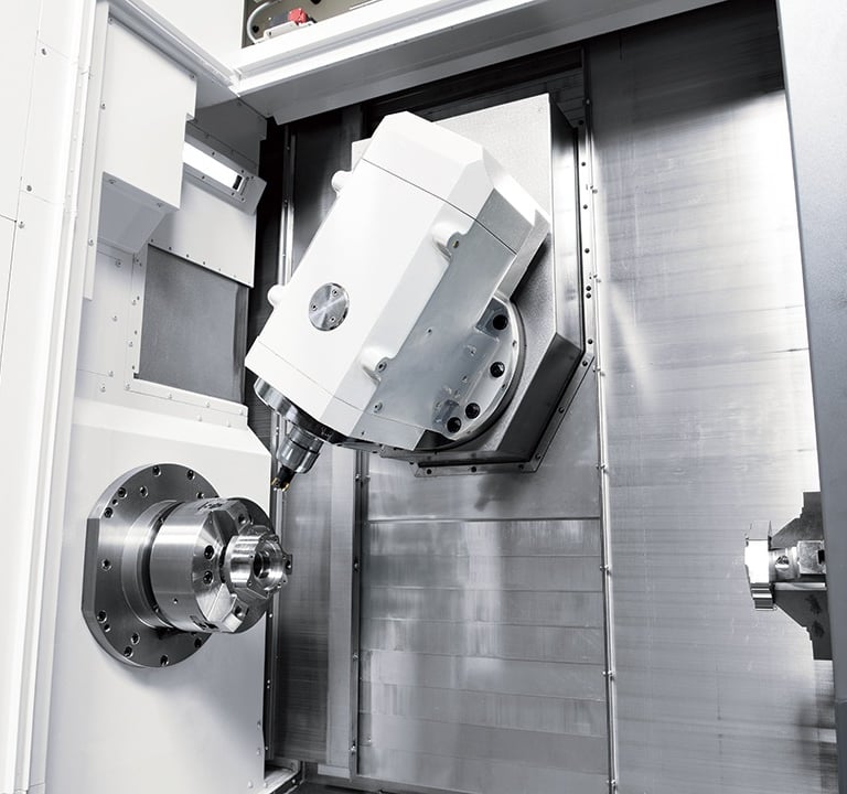 Precision 5-axis CNC milling machine spindle performing automated industrial metal machining.