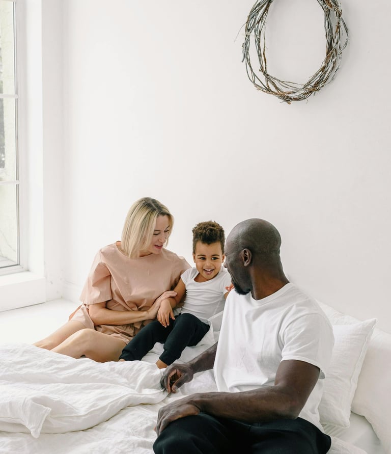 a man and woman sitting on a bed