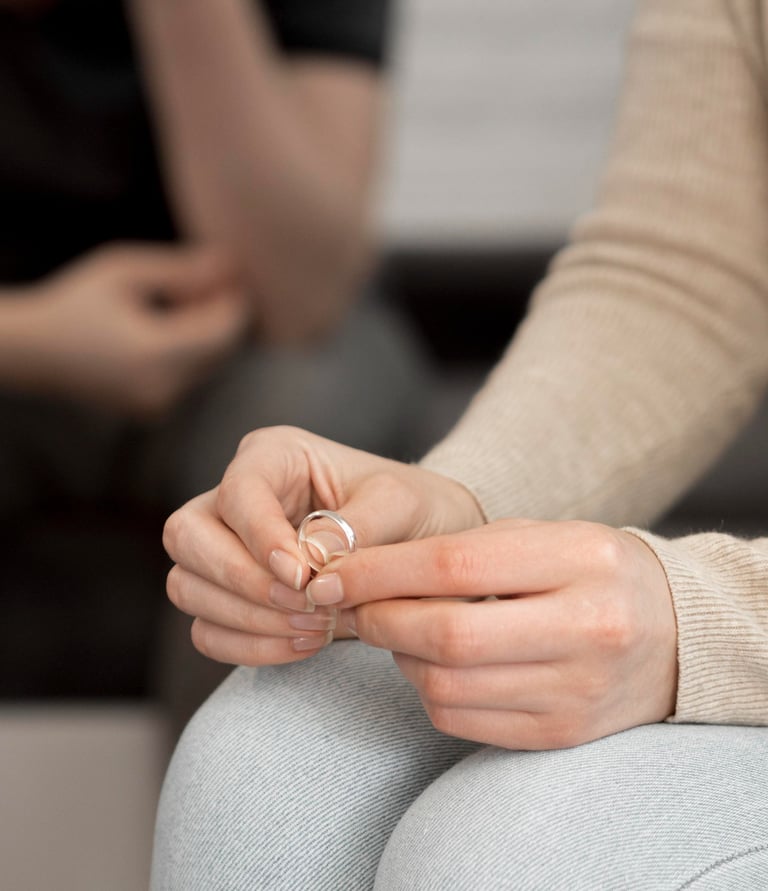 a woman sitting on a couch holding a ring