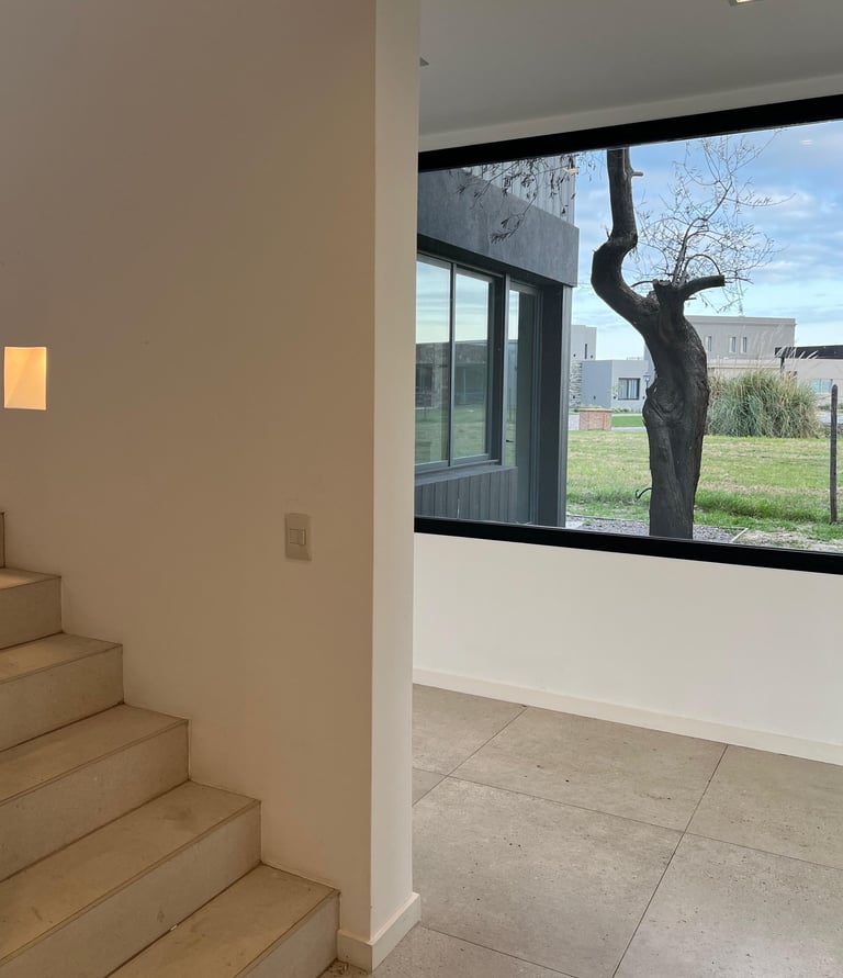 a large window with a view of a tree in the background