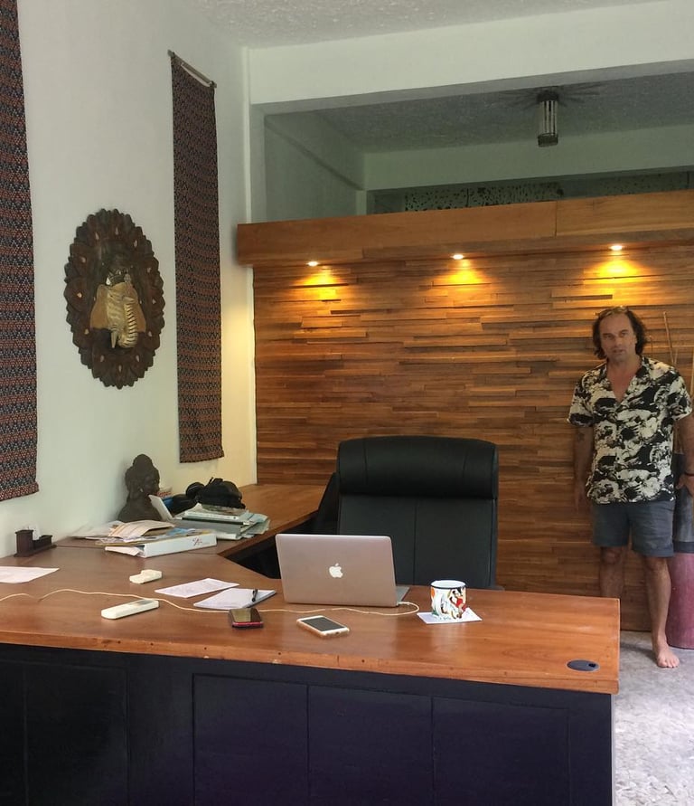 a woman standing in front of of a blines hand made desk with a laptop