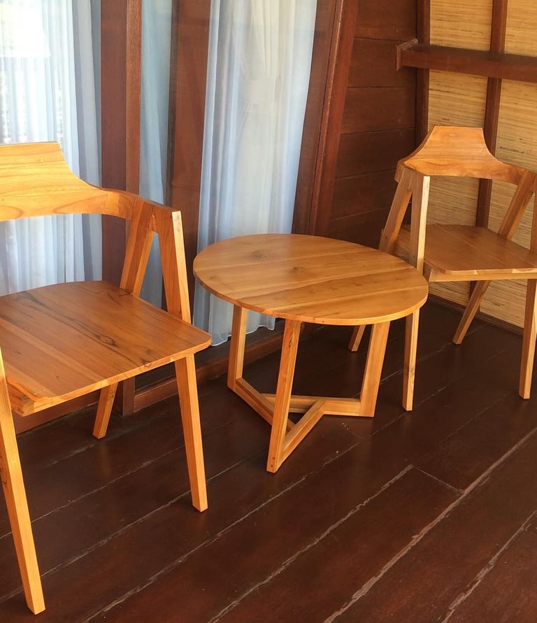 two chairs with wooden chairs and a table