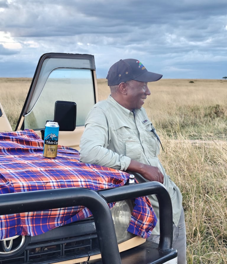 Mr Sammy in safari gear during a sundowner with clients at Maasai Mara
