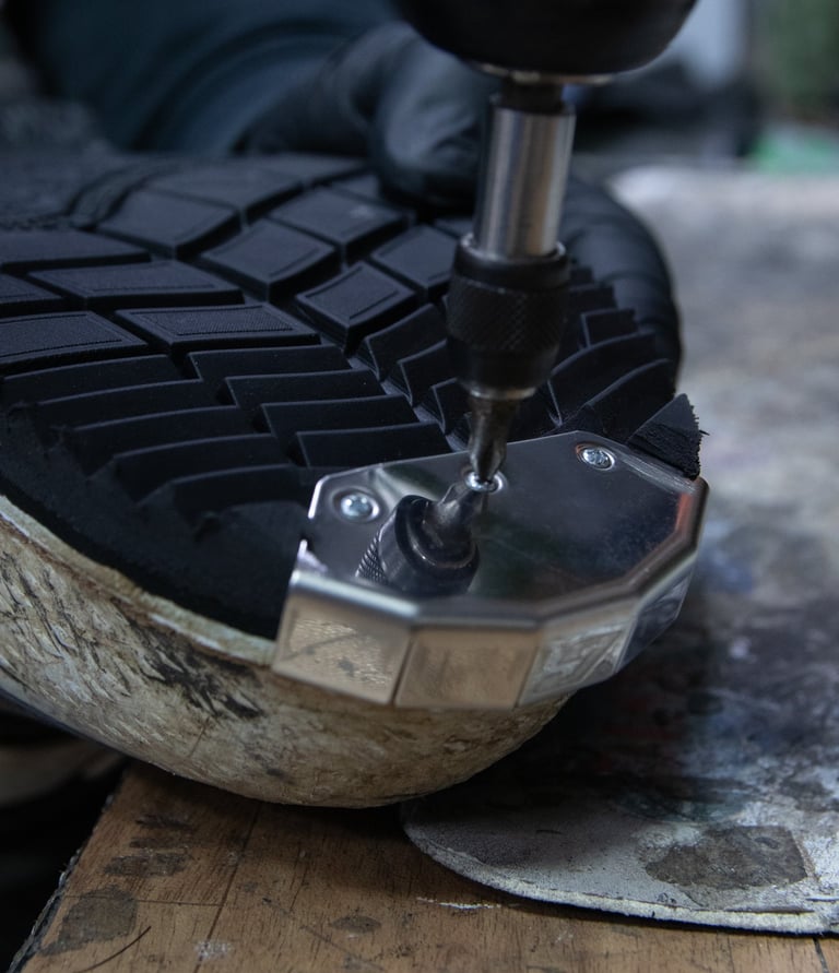 a person repairing a pair of motocross boots