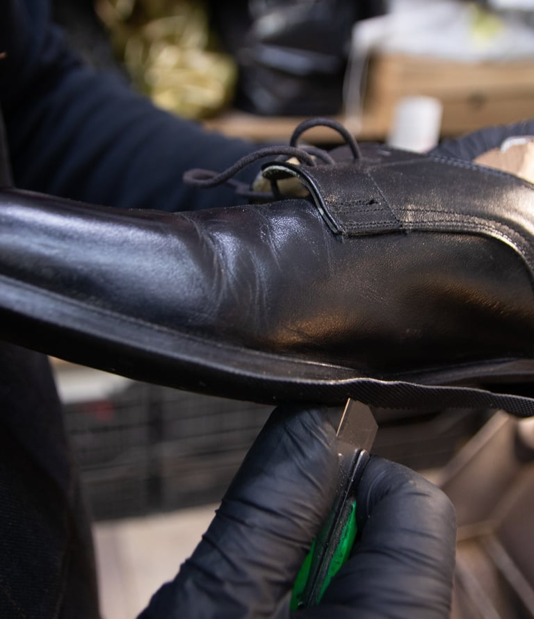 a person in gloves and gloves holding a shoe