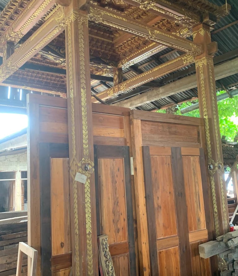 Detailed antique teak wood carving on Joglo structure showing heritage craftsmanship and cultural design elements