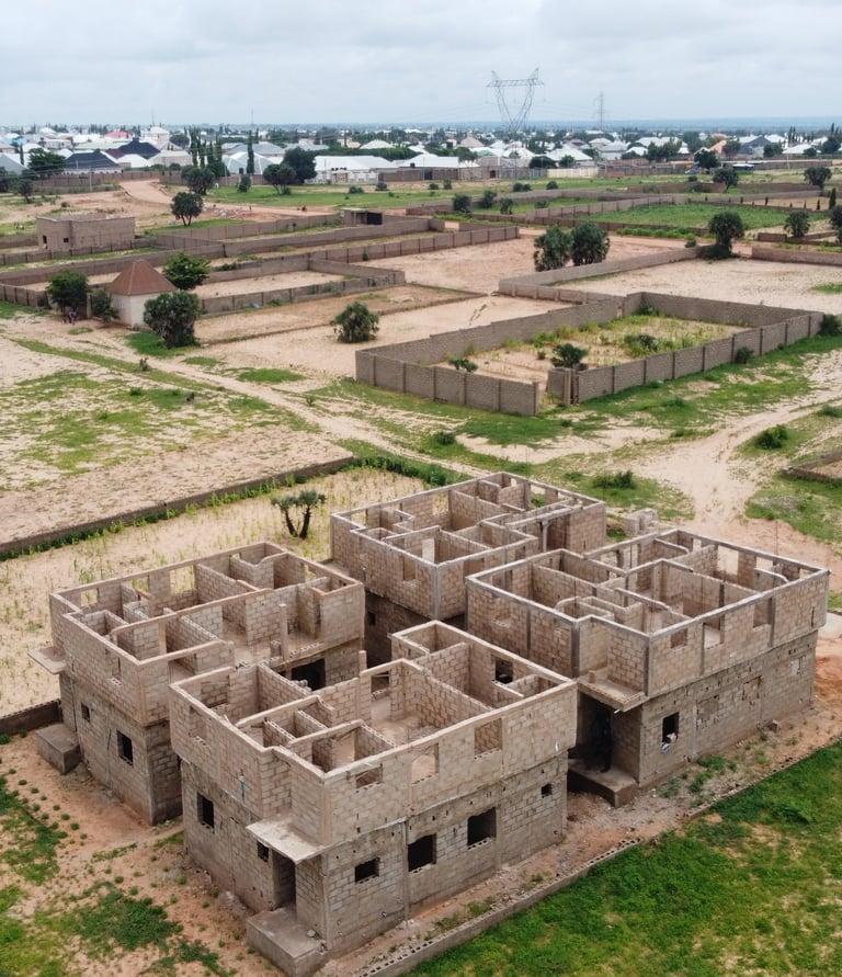 a building with a large building in the middle of a field