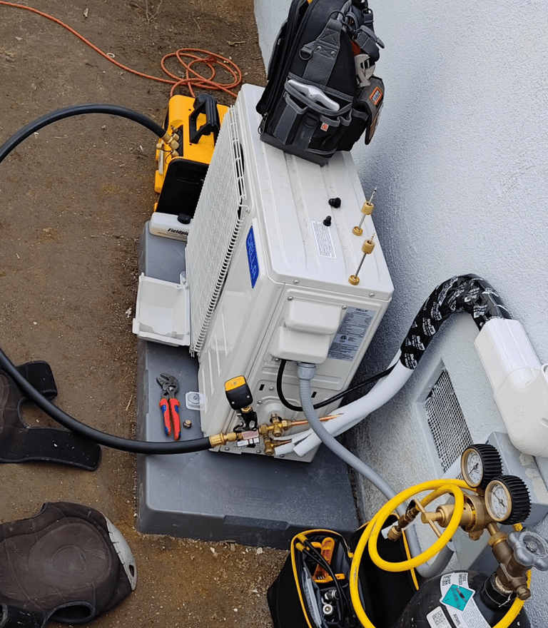 Mini split air conditioner outdoor unit being installed