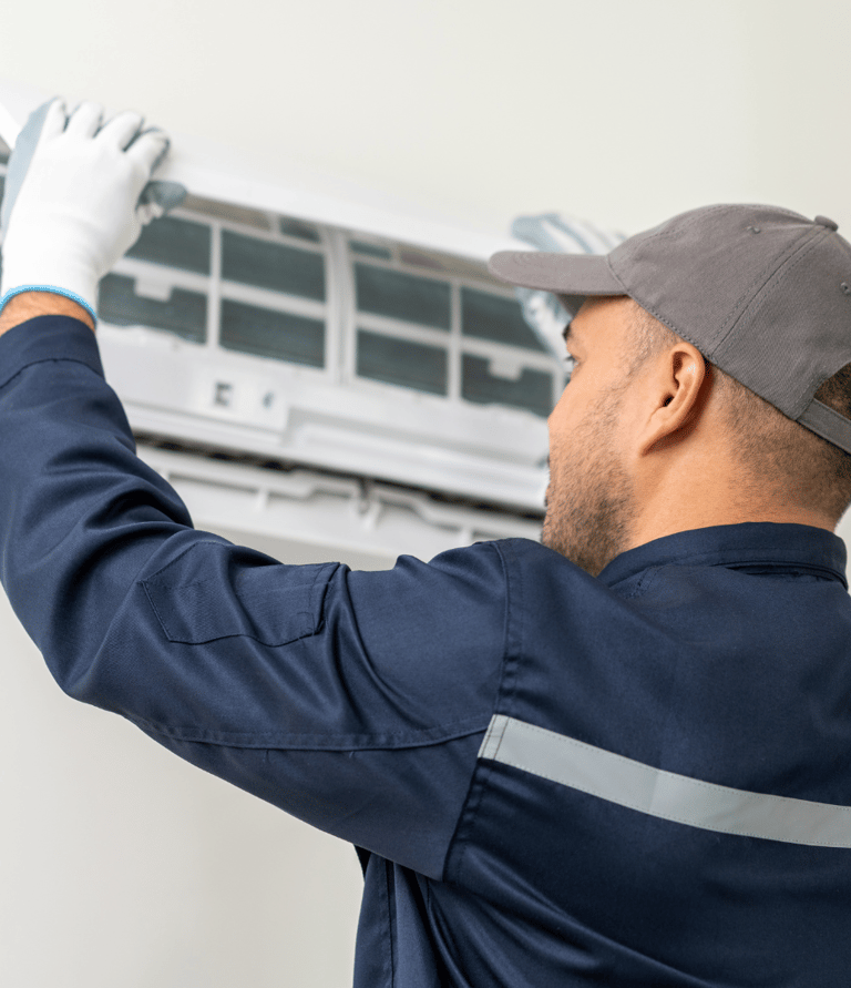 a man in a blue shirt and white gloves is holding a remote control unit climatisation