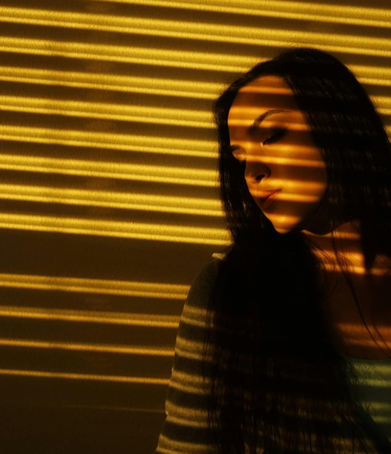 A woman standing near automated window blinds