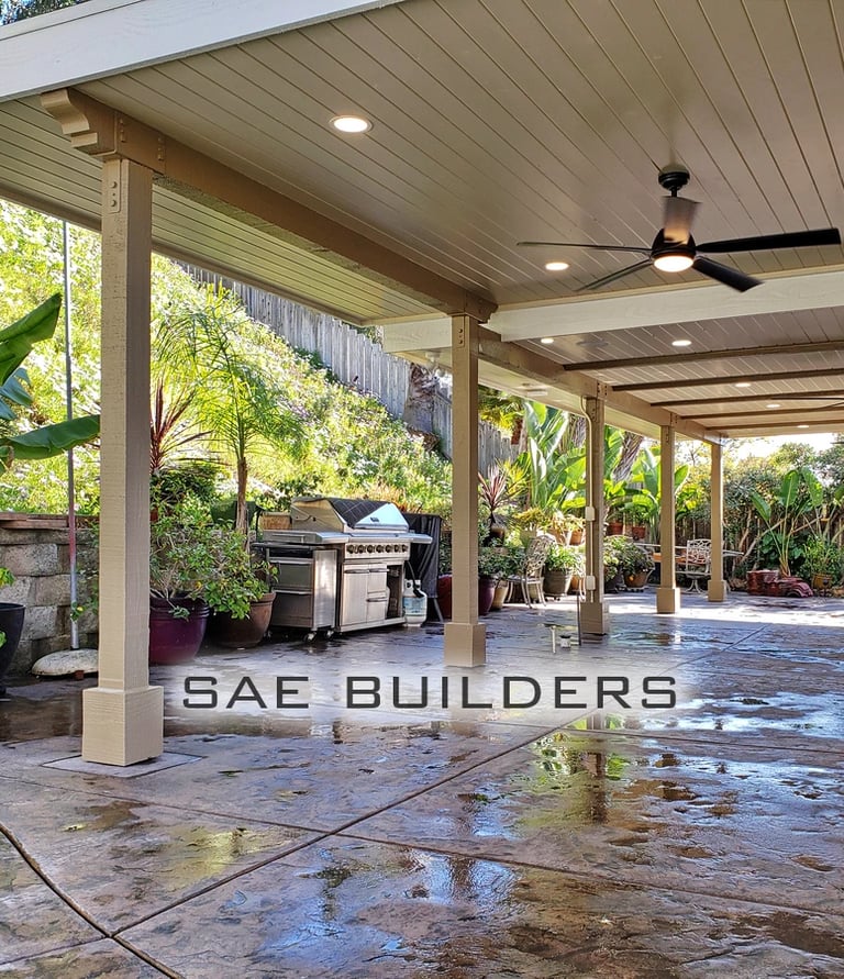 Split level wood outdoor patio area with recessed lighting and ceiling fans.