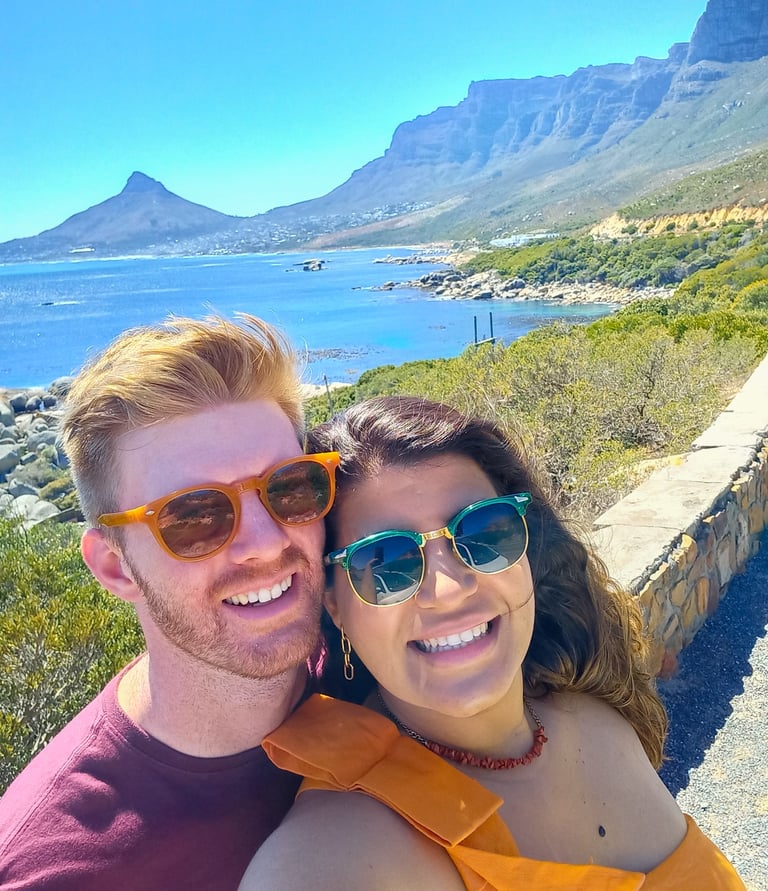 a man and woman taking a selfie with a mountain in the background