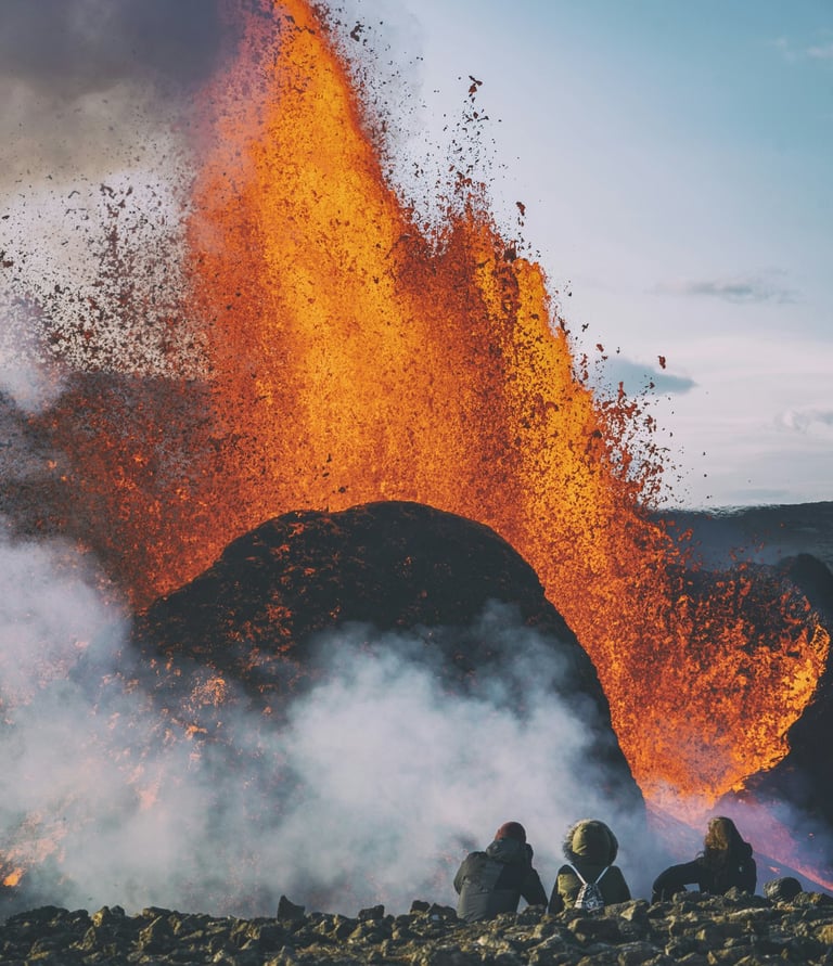 a group of people standing around a volcano