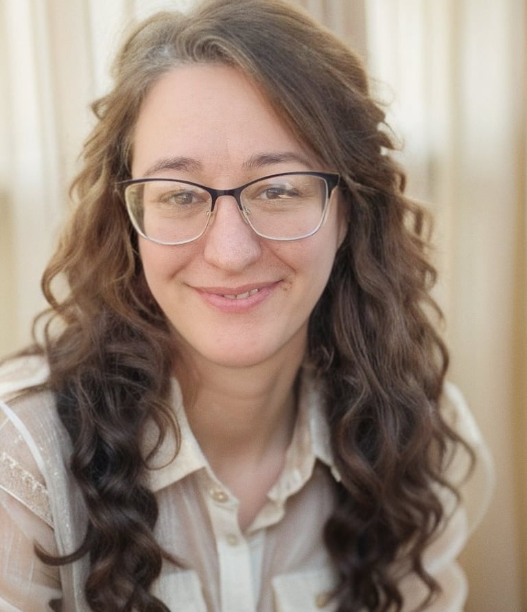 There is a picture of a woman in her mid 40's with brown wavy hair and glasses.