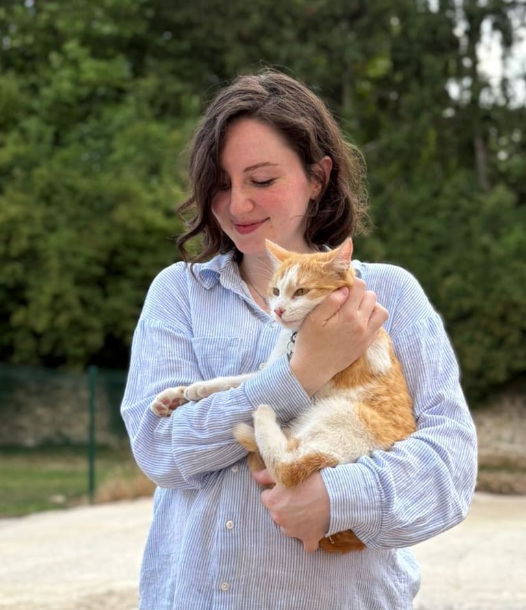 a woman holding a cat in her arms