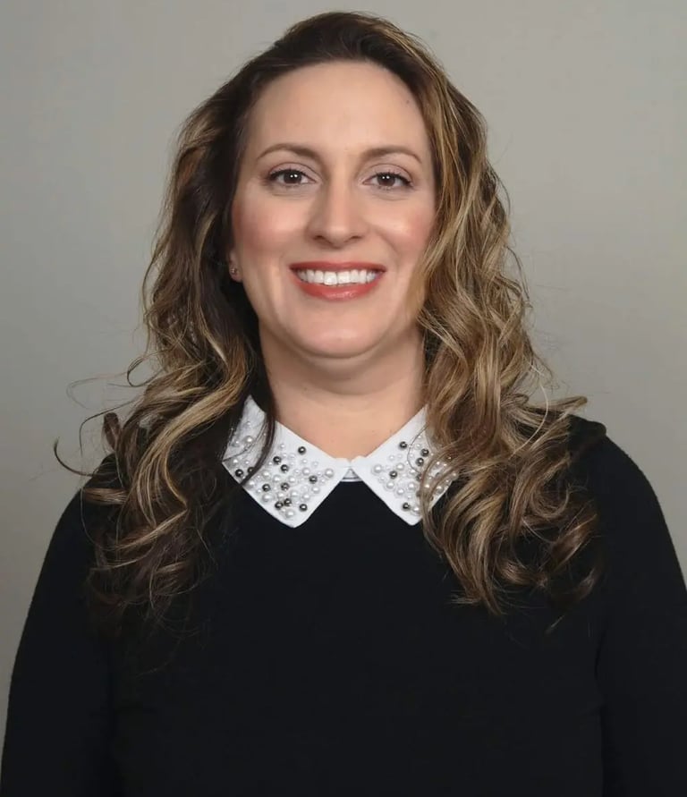 young Hispanic professional with black blouse white collar, wavy hair