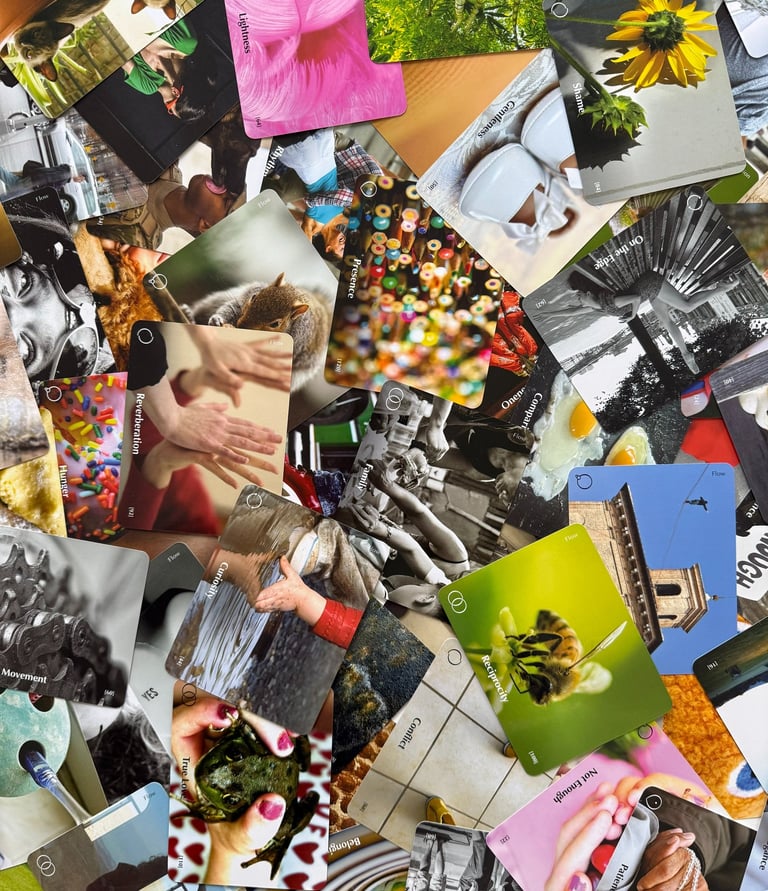 A scattered pile of inspirational oracle cards featuring nature photography and words like mindfulness, presence, and