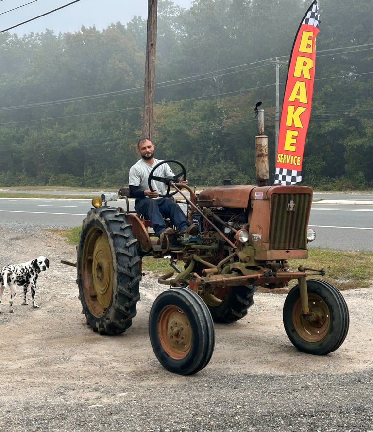 Shop owner driving around a tractor that he just fixed