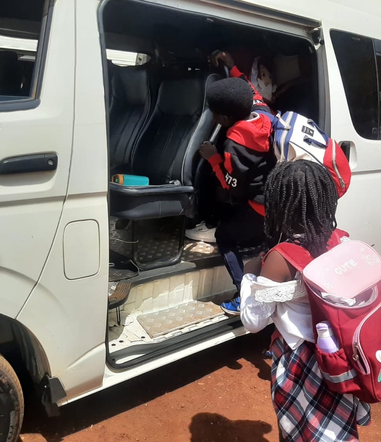 Students wearing backpacks board a white school van by Vanna Ventures for private transport.