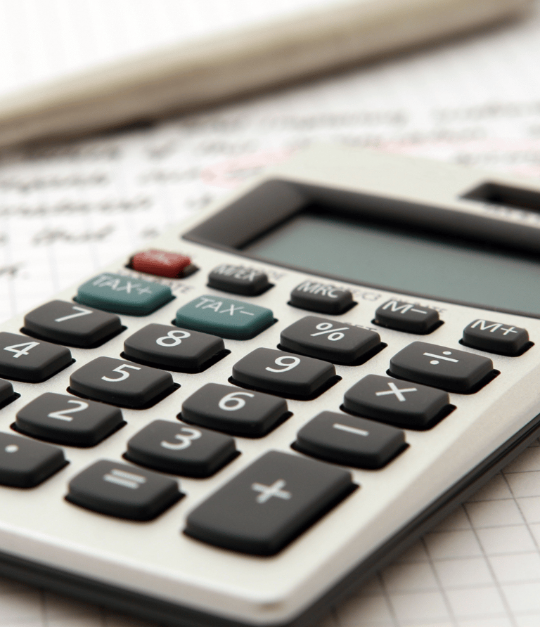 a tax calculator with a pen and a pen