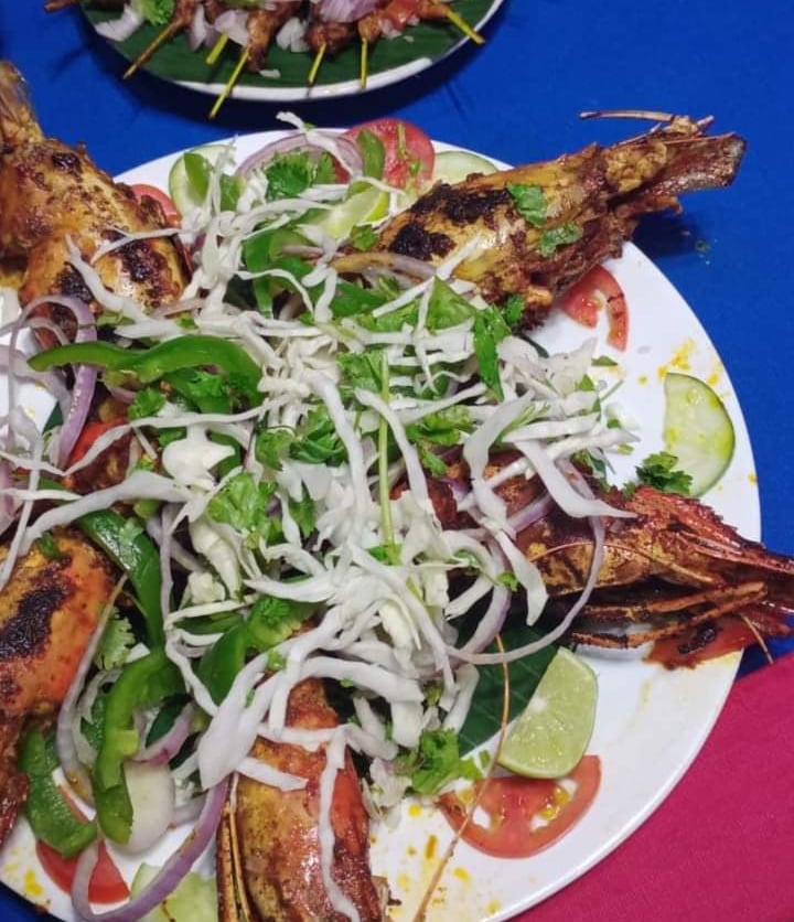 a plate of grilled fish with a salad
