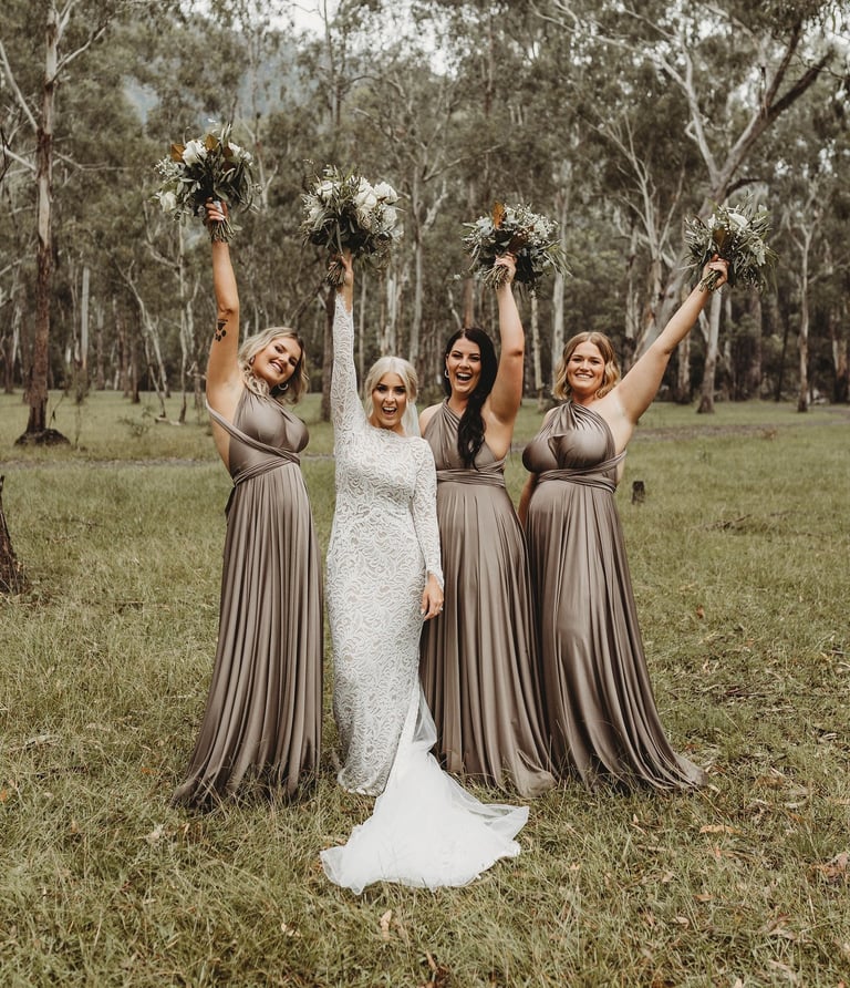 a bride and her bridesmaid posing for a photo