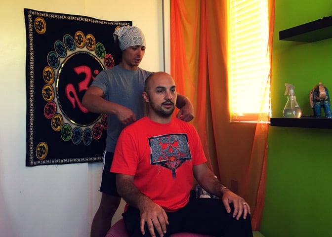 Joshua Fabia doing bodywork on a man