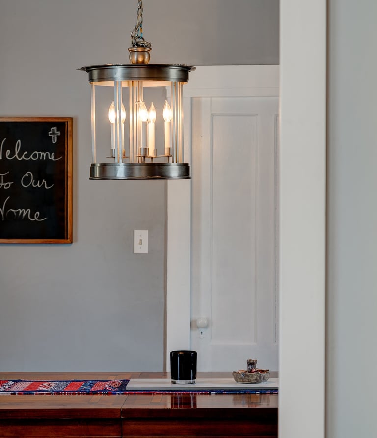 a light fixture hanging over a dining room table