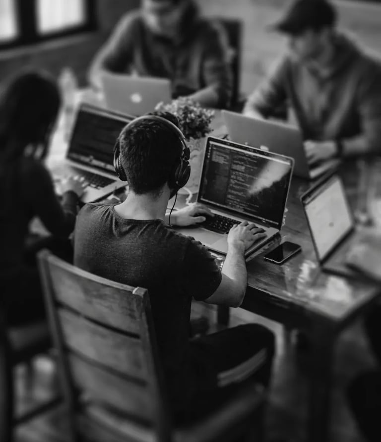 high vw of a group of people working at an office, seating on their desks