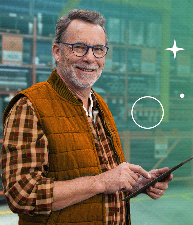 a man in a vest and glasses holding a cell phone