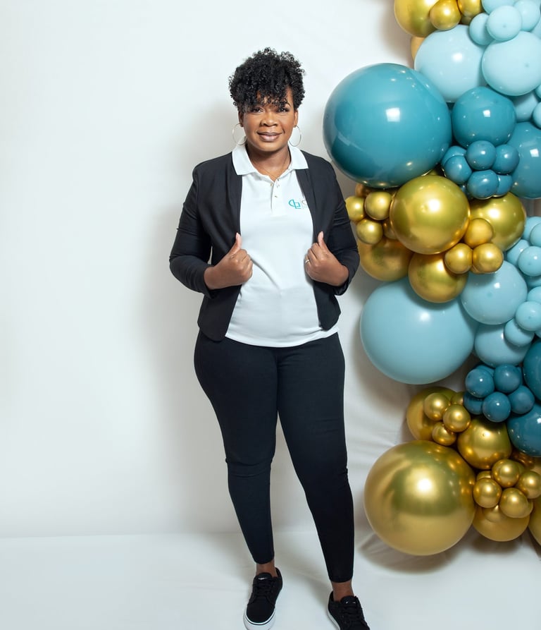 a woman in a black jacket and white shirt stand beside balloon