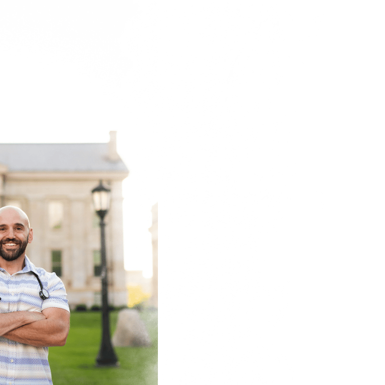 Peter Rosen, FNP with Connected Care NP standing in front of the Old Capitol building in Iowa City