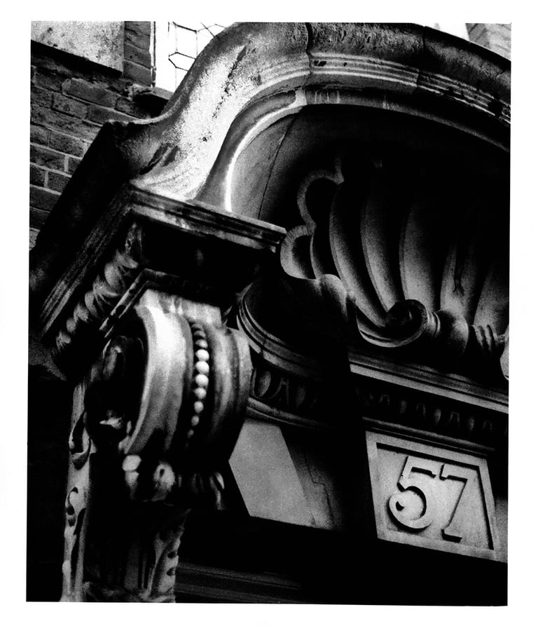 A black and white picture of the Victorian architecture - entrance to the house number 57 in London. Author: Slawek Dejneka