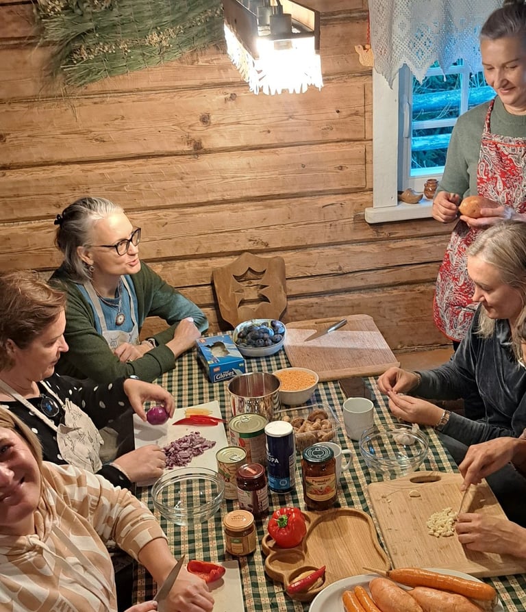 a group of people sitting around a table with food