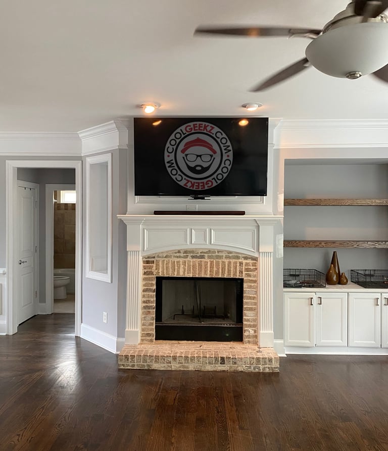 tv installed over a fireplace with hidden wires