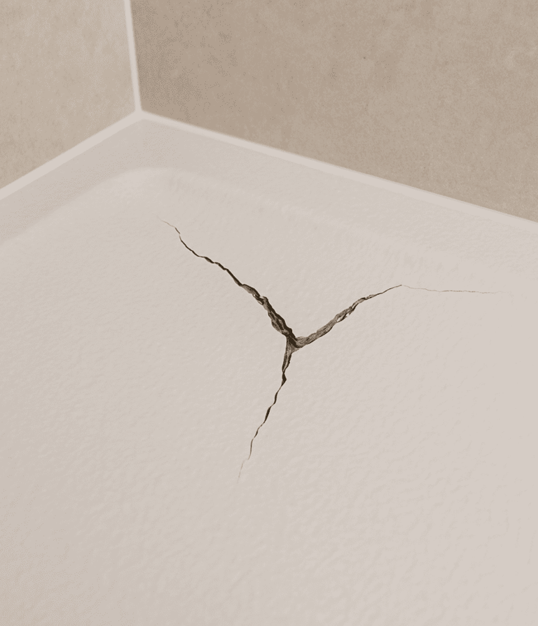 Close‑up of a cracked shower tray surface – detail of a damaged tray in an Auckland bathroom