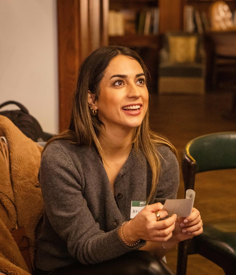 Female workshop participant, smiling during public speaking exercise in Berlin
