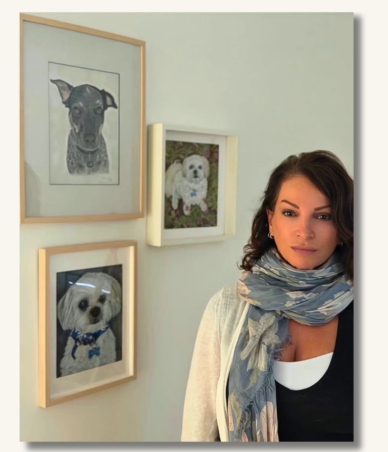 Australian pet portrait artist Sharan with framed dog portraits in her Gold Coast studio.