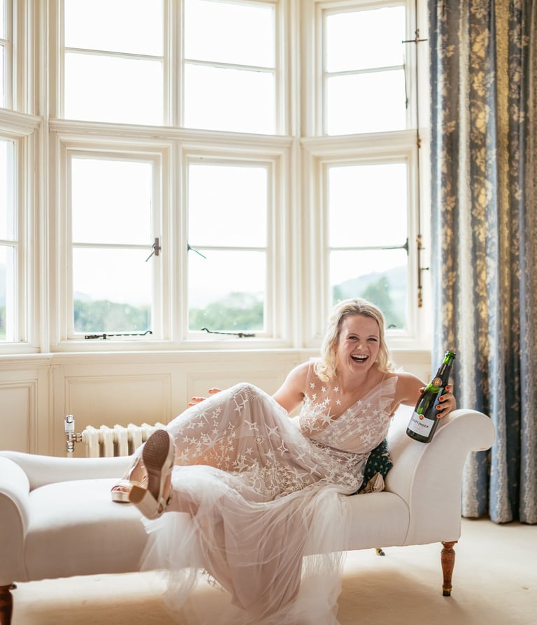 a woman in a white dress sitting on a couch